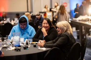 Couple of ladies laughing and talking at 5year anniversary event