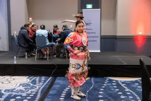 Female dancer in traditional attire doing ceremonial dance at AIOC 5year anniversary event