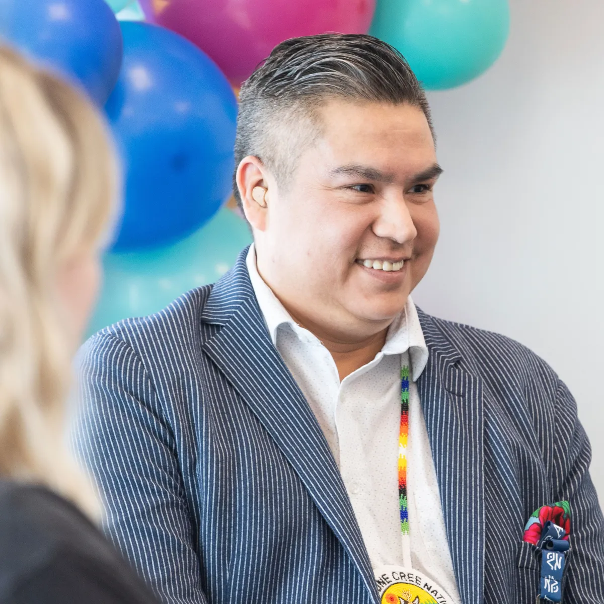Gentleman smiling in conversation at AIOC Enoch office opening
