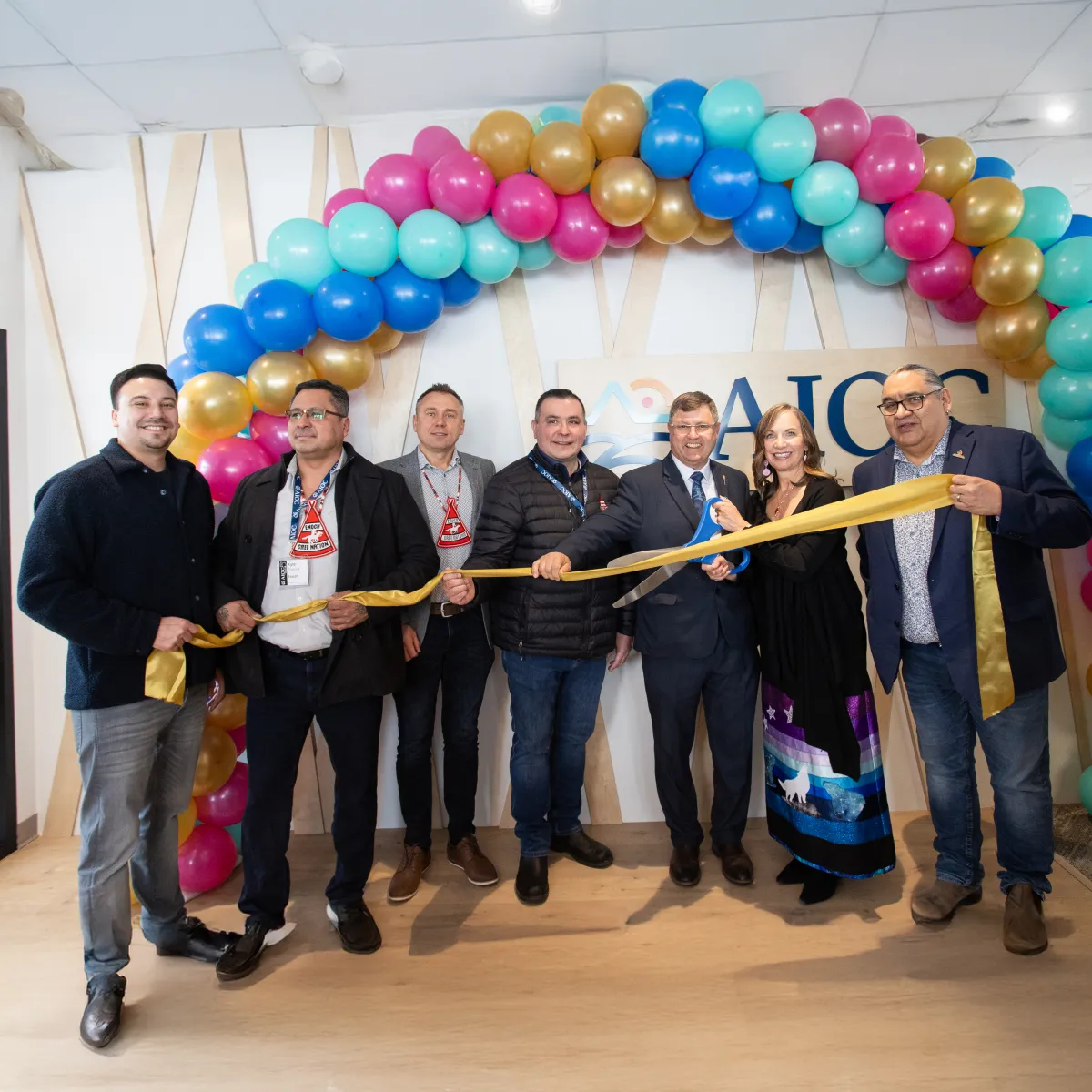 Group cutting the ribbon at the AIOC enoch office opening