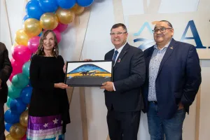 Three people accepting a gift