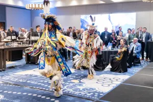 Two dancers in traditional attire doing ceremonial dance at aioc enoch office opening