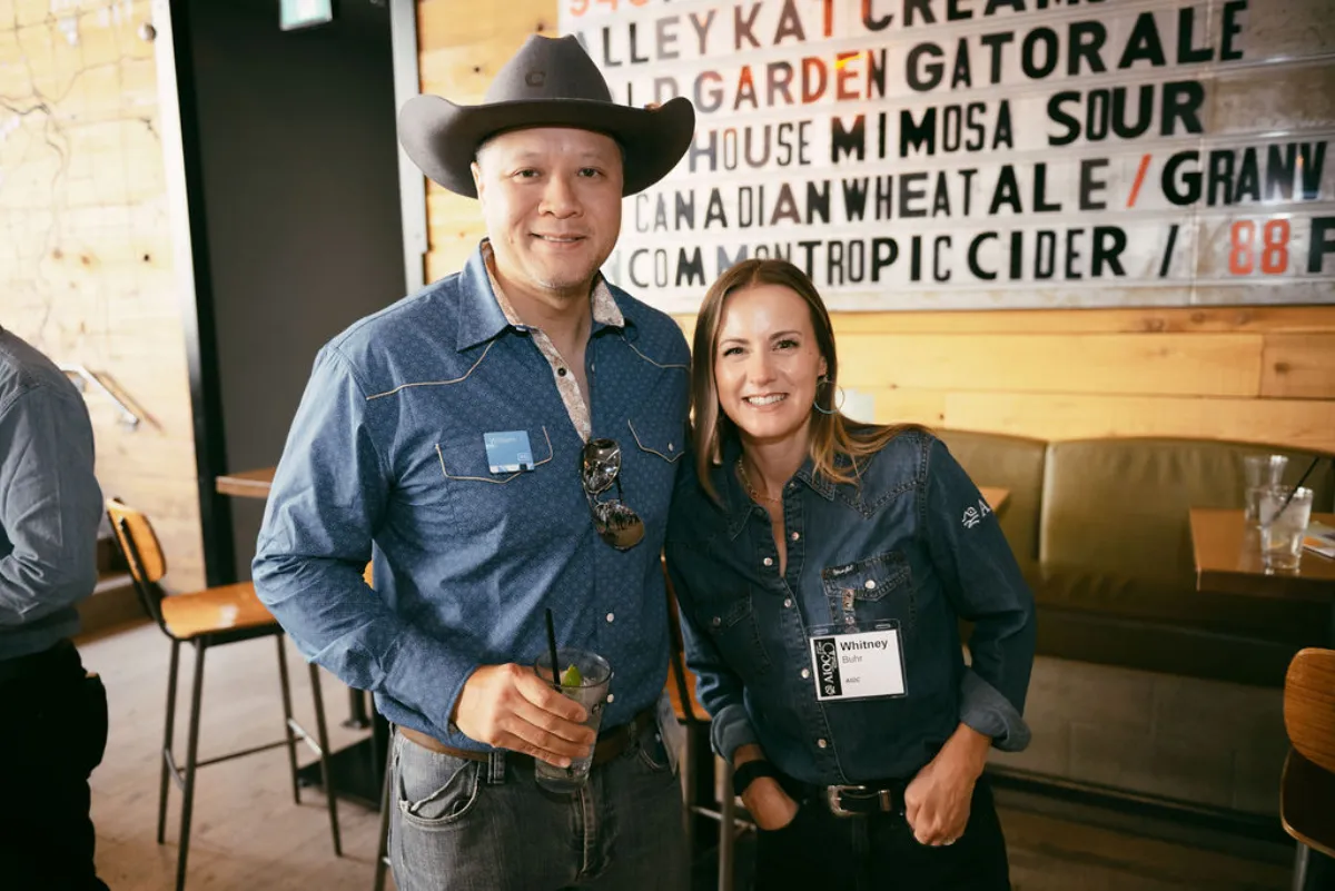 Man and woman posing for a photo and AIOC event