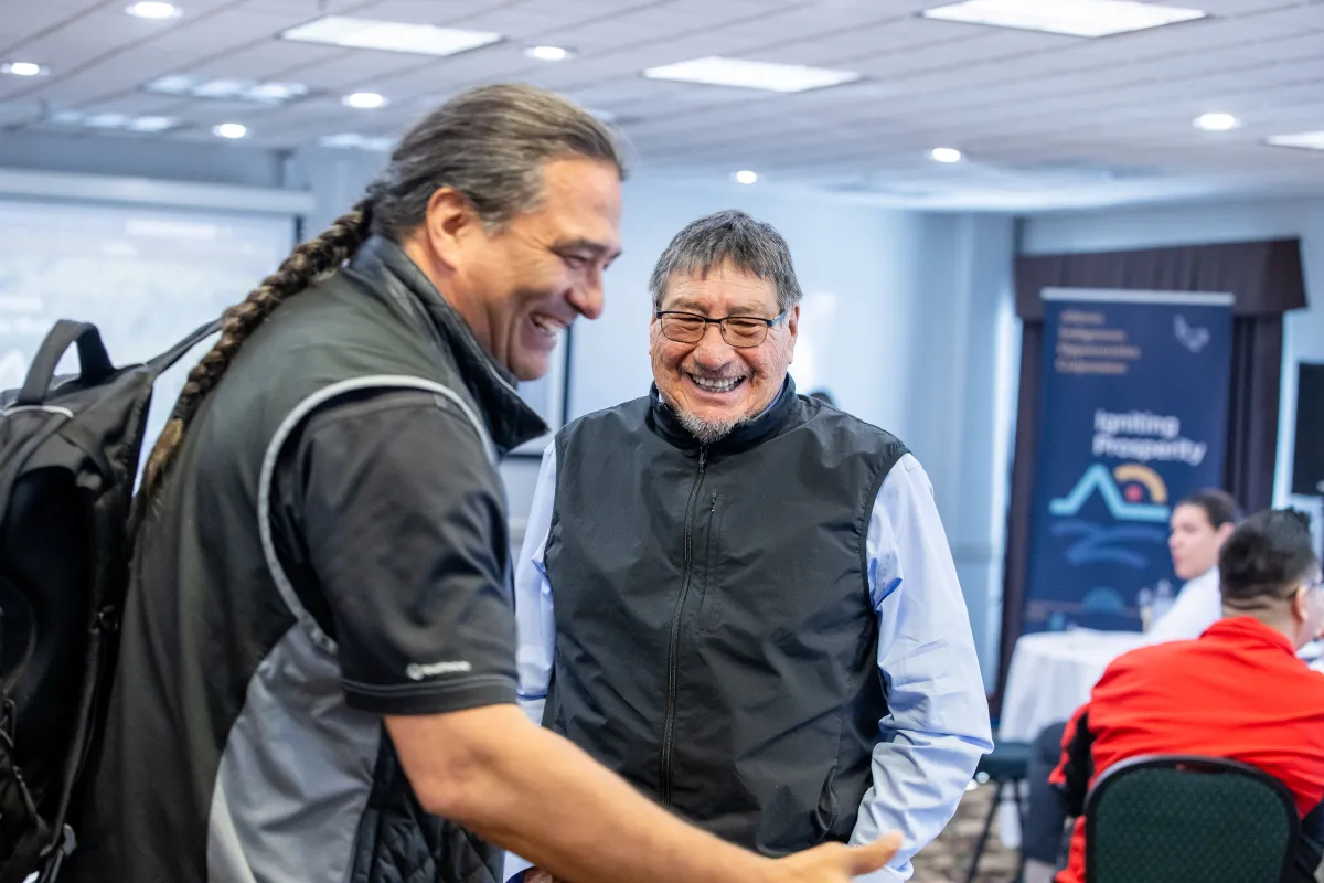 Two men chatting and smiling